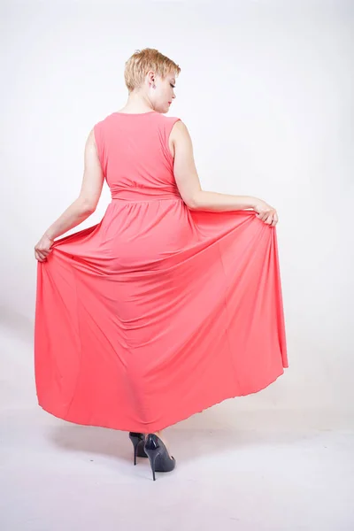 Portrait of short-haired plump woman in pink evening dress — Stock Photo, Image