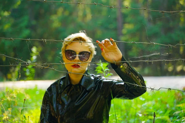 Mujer de moda de goma de látex caminando en el bosque —  Fotos de Stock