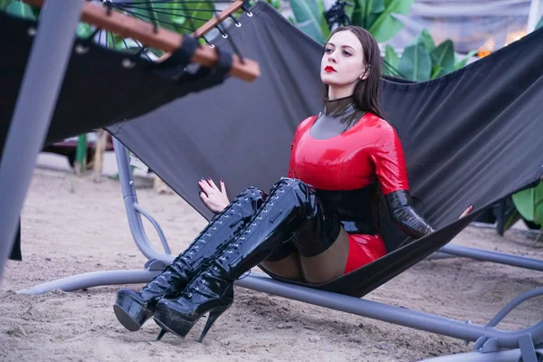 Mode élégante dame porter des vêtements en caoutchouc de latex sur la plage de plein air — Photo