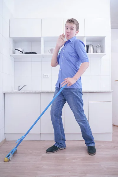 Teenager Boy Mopping The Floor and helps his parents to clean on kitchen — Stock Photo, Image