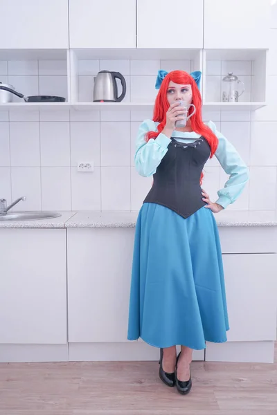 Young red hair girl in blue dress with black corset on the kitchen — Stock Photo, Image