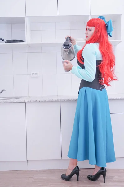 Young red hair girl in blue dress with black corset on the kitchen — Stock Photo, Image