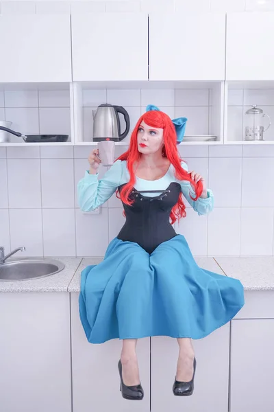 Young red hair girl in blue dress with black corset on the kitchen — Stock Photo, Image