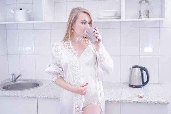 Sexy jeune femme en lingerie blanche dans sa cuisine . — Photo