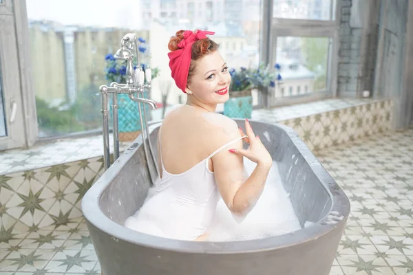 Seksi kadın banyoda köpük ile vücut ovuşturuyor