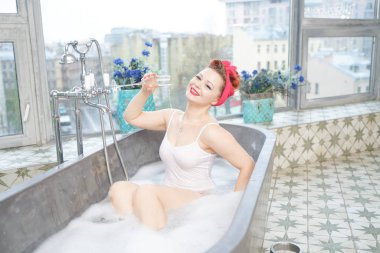 Baştan çıkarıcı kadın banyosunda şampanya ile rahatlatıcı banyo alıyor