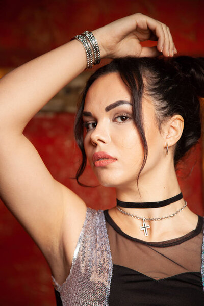 Fashion young woman with smooth armpit on red background