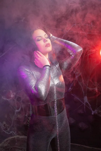 Futuristic Space fashion person in silver stylish outfit in the smoke — стоковое фото