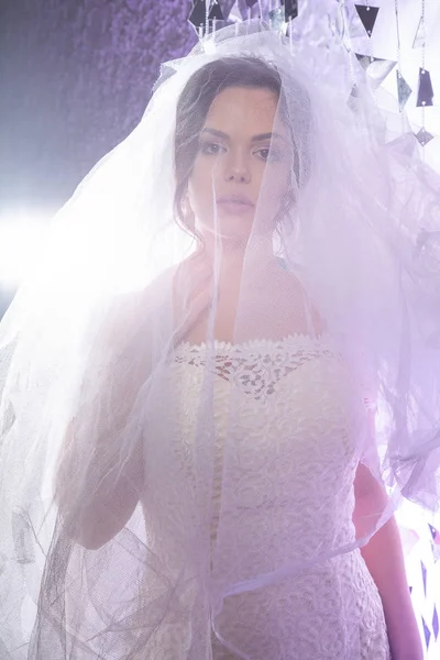 Portrait of the beautiful bride against a light indoors in the smoke — Stok Foto