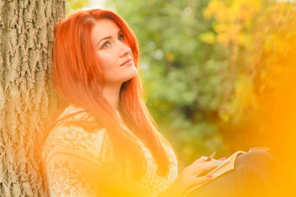 Mulher ruiva bonita jovem em camisola caminha no outono — Fotografia de Stock