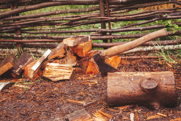 Axe in the stump. the wood lay on the ground near