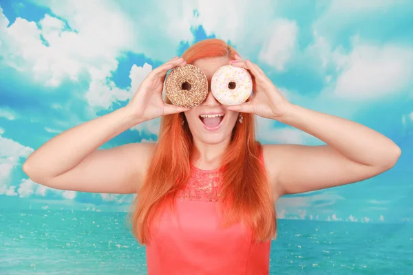Close up retrato de uma menina bonita satisfeito comer donuts sobre fundo azul — Fotografia de Stock