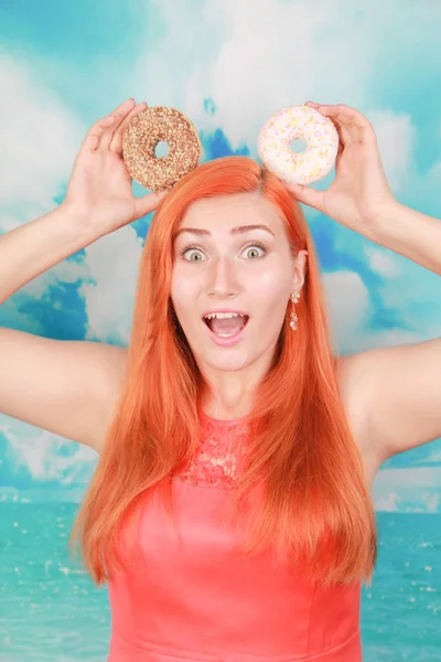 Close up retrato de uma menina bonita satisfeito comer donuts sobre fundo azul — Fotografia de Stock