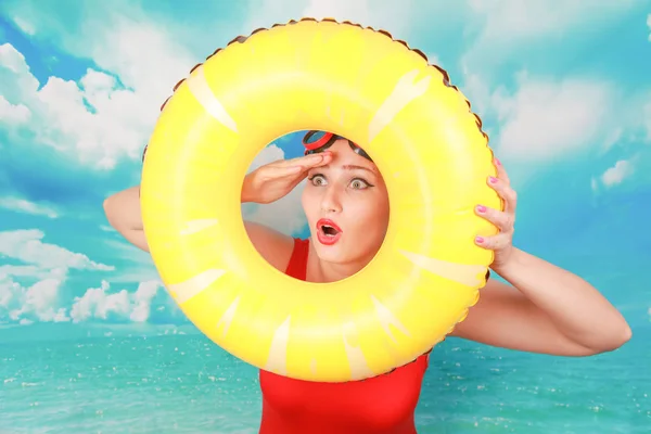 Studio shot of Beauty sexy women wear red vintage swimsuit and carrying life ring on blue sky background — Stock Photo, Image