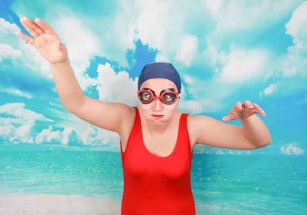 Crazy diver in red swimsuit with swimming goggles on blue background. person swimmer learn to swim. — Stock Photo, Image