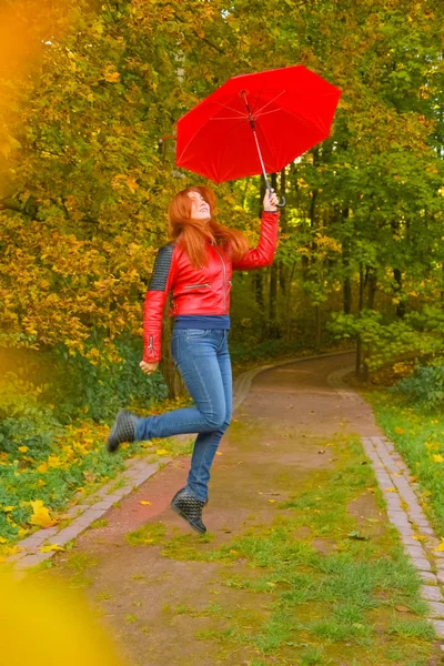 젊은 예쁜 플러스 크기 백인 여자 가을 공원에서 빨간 우산 산책 — 스톡 사진