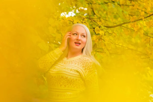 Jeune jolie plus taille femme caucasienne en pull blanc promenades dans le parc d'automne — Photo