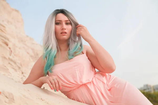Jovem bela mulher caucasiana deitada na paisagem do deserto com areia . — Fotografia de Stock