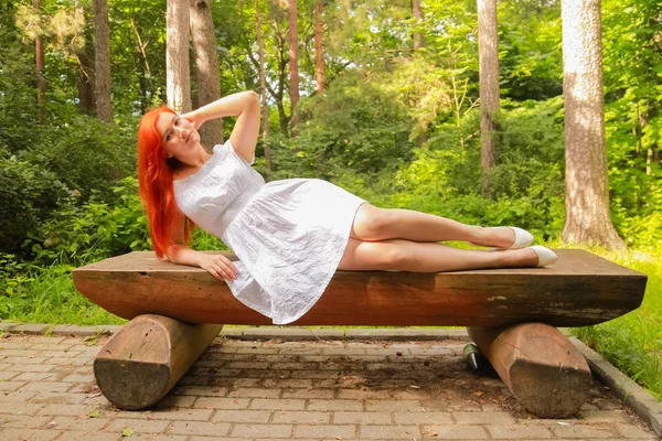 Pretty red hair girl walking in white cotton dress in the park — Stock Photo, Image