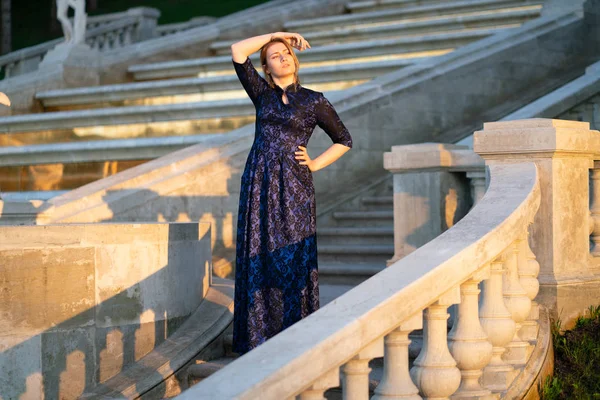 Lady in abito di pizzo blu passeggiando in città al tramonto — Foto Stock