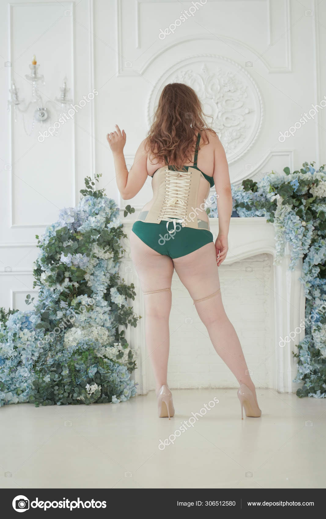 Beautiful plus size woman smiling happily in underwear