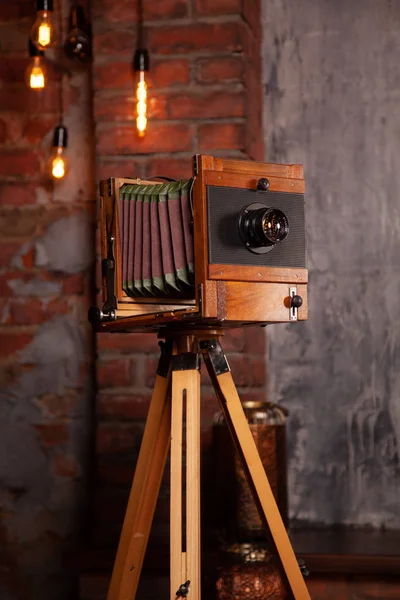 a very old rarity photo camera stands on a tripod in the Studio. nobody