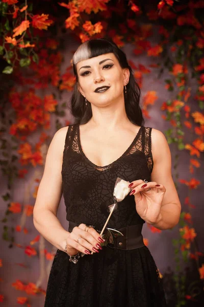 레이스 고딕 핀을 단 검은 머리의 얇은 패션의 할로윈 소녀 가을 배경에 가을 나뭇잎을 입고 포즈를 취하다 — 스톡 사진