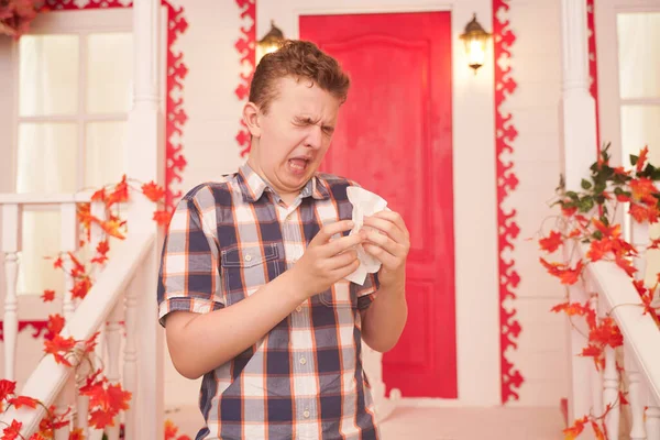 Studiofoto van een jongeman met zakdoek. Zieke man heeft een loopneus. de mens maakt een remedie tegen de verkoudheid — Stockfoto