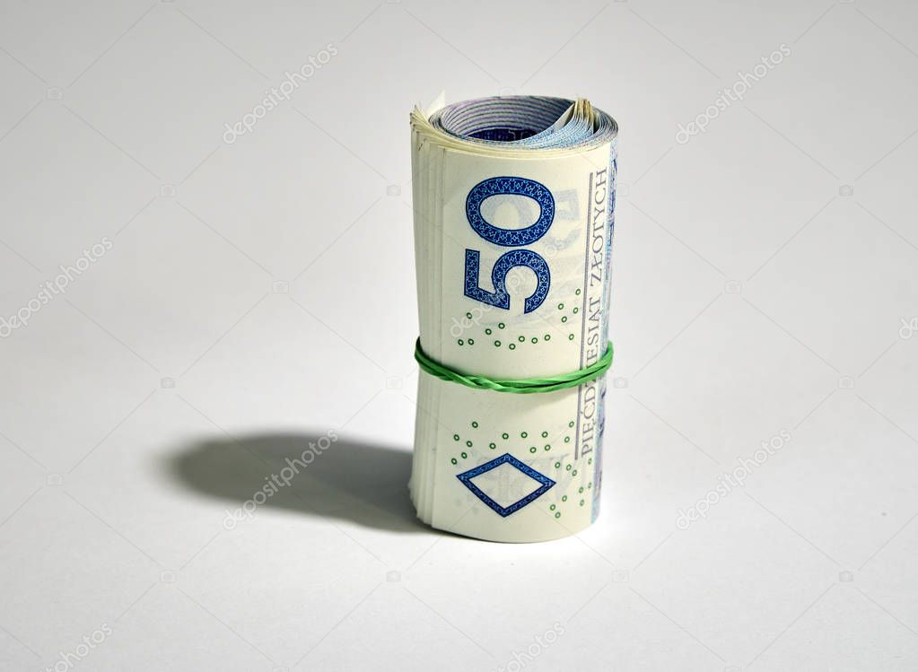 Rolled up polish money (PLN) - fifty polish zloty bills isolated on a white background