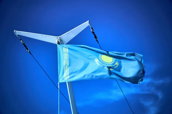 flag of Kazakhstan on the mast of the ship n Bukhtarma artificial reservoir, formed by the dam of the Bukhtarma hydroelectric station on the Irtysh river, Kazakhstan