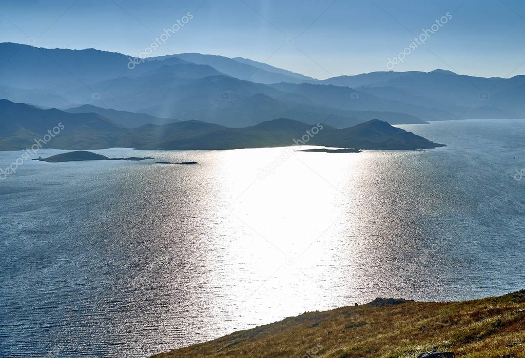 Beautiful panoramic aerial summer view at sunset to the Bukhtarma artificial reservoir, formed by the dam of the Bukhtarma hydroelectric station on the Irtysh river, Kazakhstan