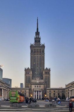 WARSAW, POLAND - APRIL 07, 2019: Beautiful evening wide-angle panoramic view from the street to iew of the Palace of Culture and Science (PKiN) - the largest symbol and the tallest building in Warsaw clipart