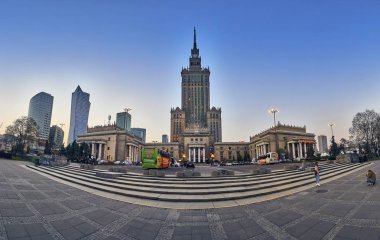 WARSAW, POLAND - APRIL 07, 2019: Beautiful evening wide-angle panoramic view from the street to iew of the Palace of Culture and Science (PKiN) - the largest symbol and the tallest building in Warsaw clipart