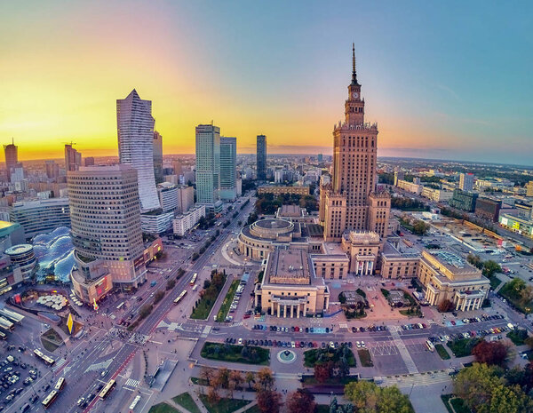 Beautiful panoramic aerial drone view at sunset to the center of Warsaw City and Palace of Culture and Science - a notable high-rise building in Warsaw, Poland
