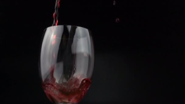Pouring Red Wine Wineglass Black Background Slow Motion — Stock Video