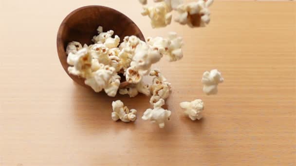 Popcorn Fällt Zeitlupe Auf Einen Holztisch — Stockvideo