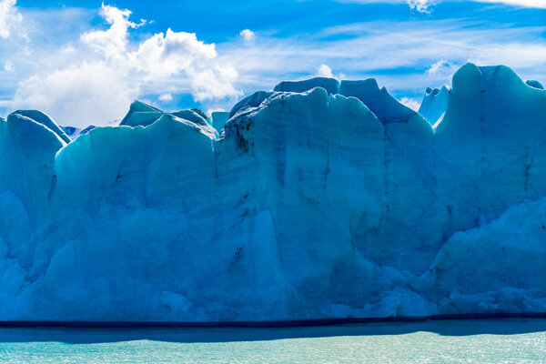 View of blue ice of Glacier Grey and Grey Lake in sunny day at T