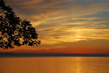 Lindau, Almanya: Bir görünümünü Bodensee (aka Bodensee), uzaktan Avusturya ve İsviçre, yaz aylarında gün batımında. Lindau pozisyonda: toz Kulesi (Almanca: Pulverturm)