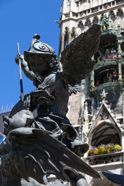 Munich, Germany: Sculpture at the base of the column on Marienplatz. Statue of a bronze putto killing dragon