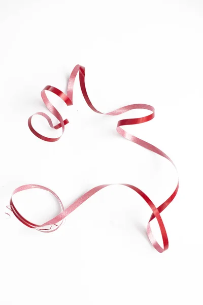 Red ribbon serpentine on white background isolate — Stock Photo, Image