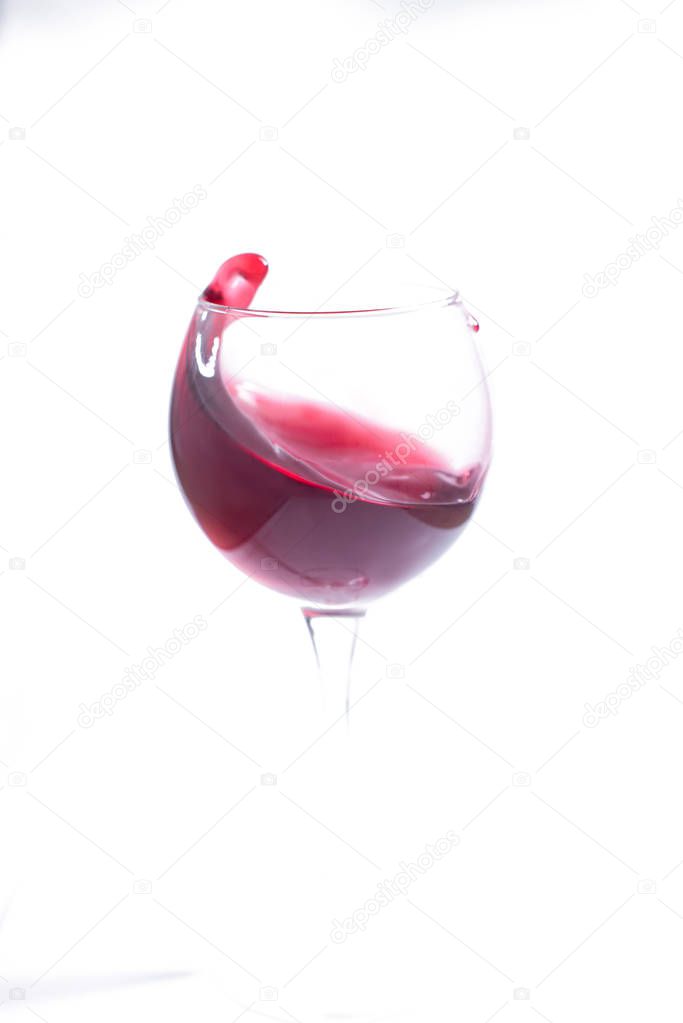 A glass with red wine on a white background. Isolate
