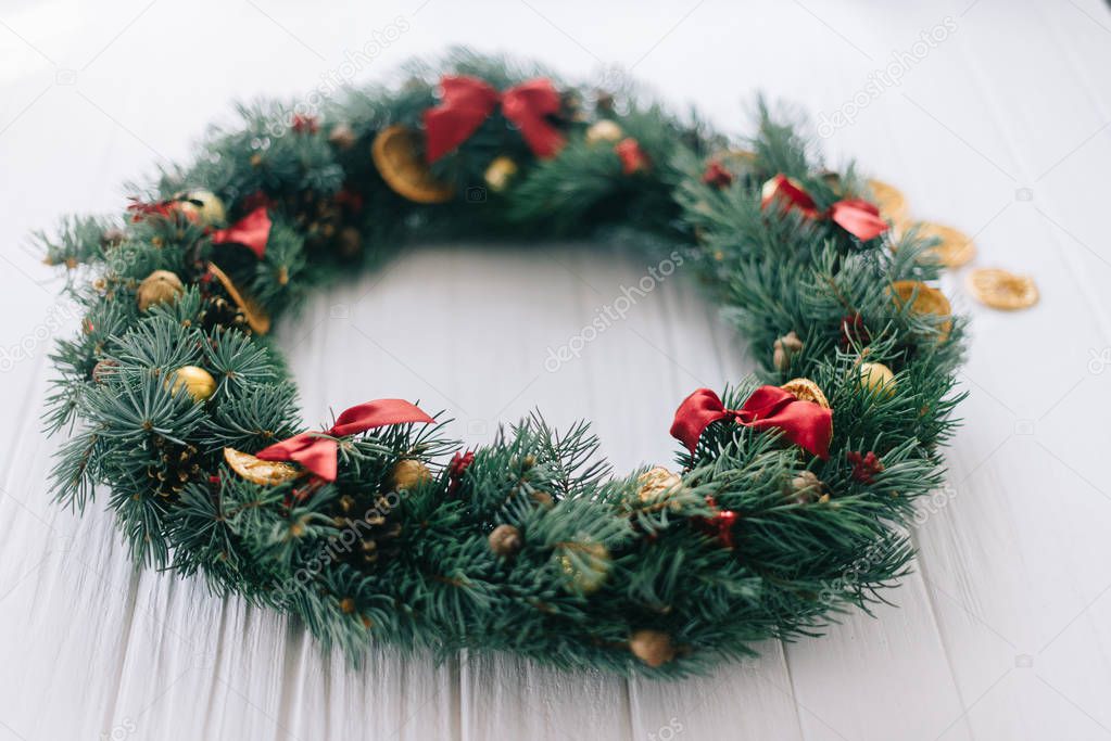 Christmas wreath on a white wooden background