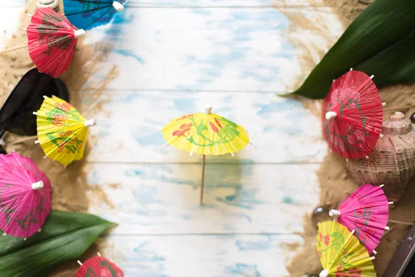 Summer concept. Beach umbrellas on a wooden blue background — Stock Photo, Image