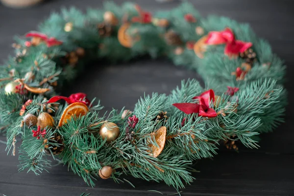 Natural Christmas wreath on black wooden background