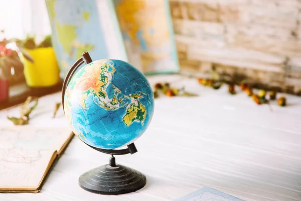 Globe on wooden white boards with a blurred background. Autumn still life — Stock Photo, Image