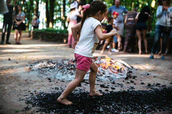 People go around the coals at a festival in Cherkassy. Ukraine, June 10, 2018
