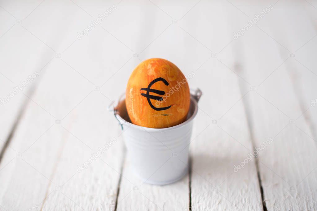 Egg with logo bitcoin in a small bucket