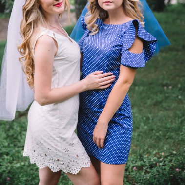 Doğada bir kız arkadaşı ile gelin beyaz bir elbise içinde. tavuk taraf