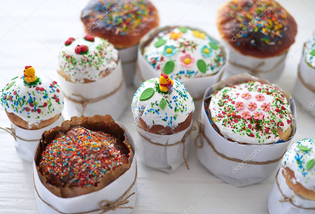 Easter cakes on white wooden background.