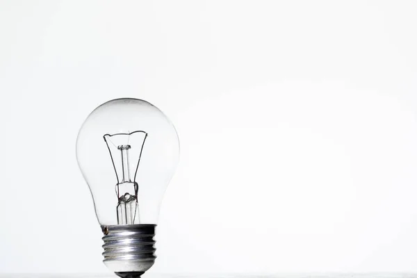 Light bulb frying on a white background isolate — Stock Photo, Image